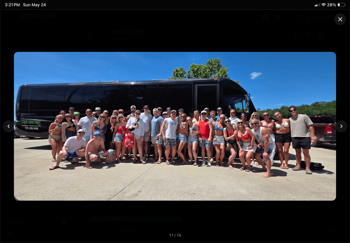Lake Ride Pros luxury transportation fleet lined up at Lake of the Ozarks including limo bus, Rescue Squad truck, SUVs, and Mercedes Sprinter vans with lake view in background
